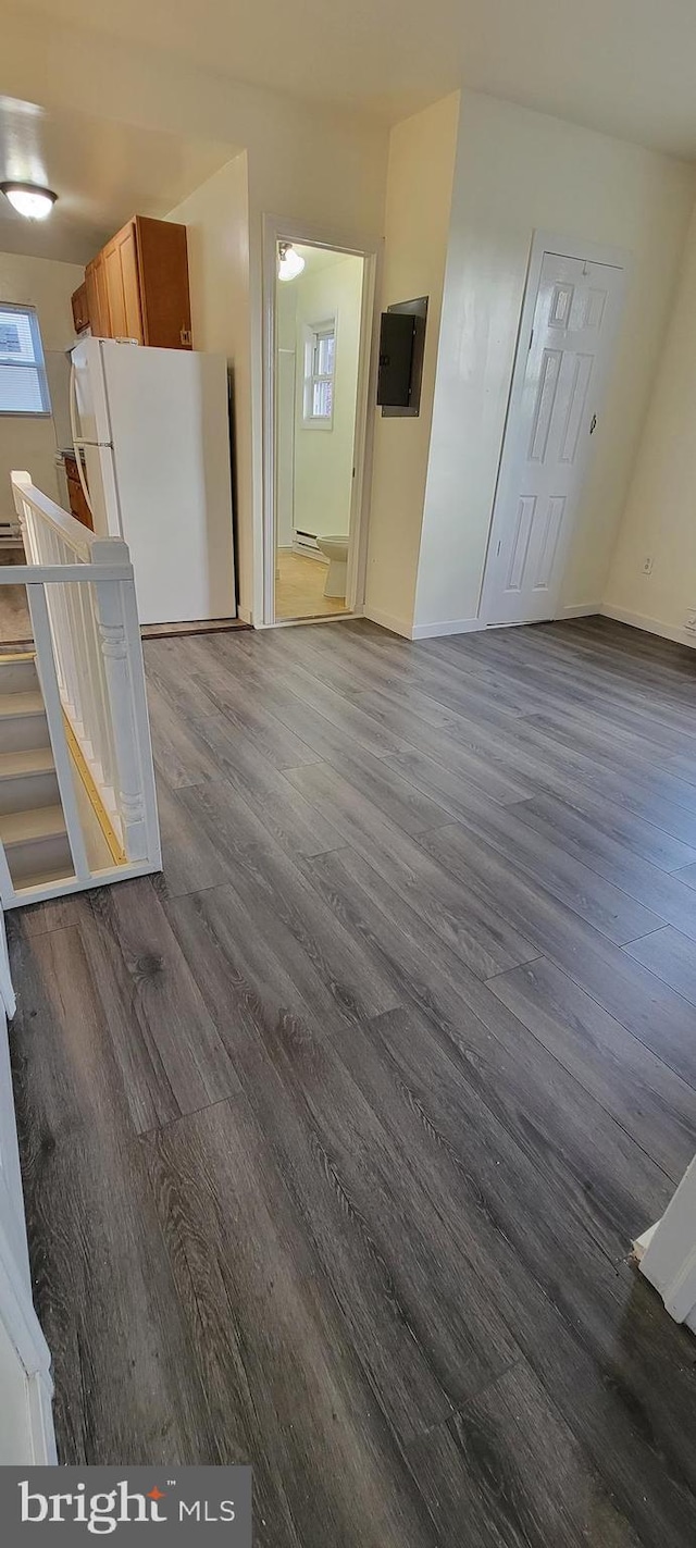 3063 Joyce St, Philadelphia, PA 19134 - kitchen with freestanding refrigerator, dark wood finished floors, baseboards, electric panel, and a baseboard radiator