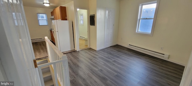 3063 Joyce St, Philadelphia, PA 19134 - kitchen with a baseboard heating unit, brown cabinetry, dark wood-style floors, and freestanding refrigerator