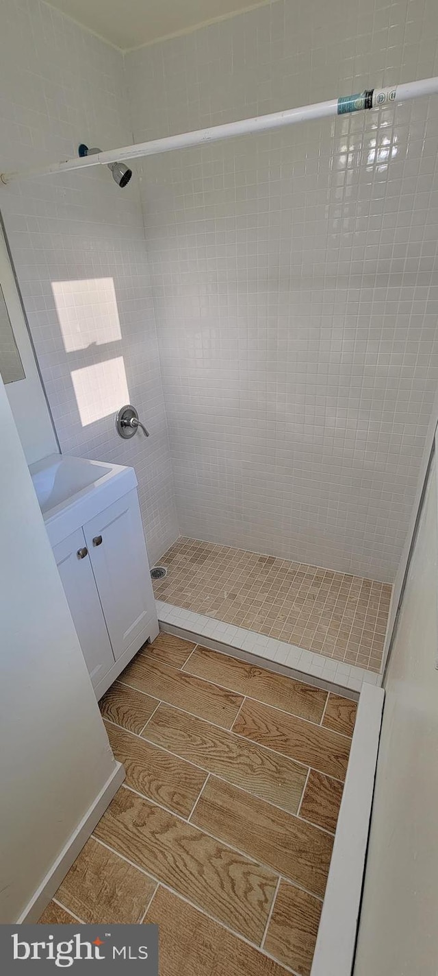 3063 Joyce St, Philadelphia, PA 19134 - bathroom featuring a shower stall, vanity, and wood tiled floors