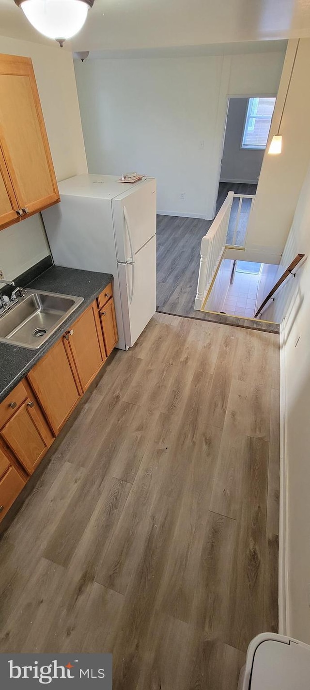 3063 Joyce St, Philadelphia, PA 19134 - kitchen with a sink, wood finished floors, and dark countertops