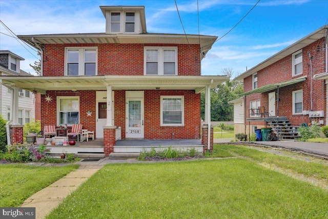 2500 Penn Ave, West Lawn, PA 19609 - traditional style home featuring brick siding, a porch, and a front yard