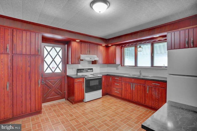 2500 Penn Ave, West Lawn, PA 19609 - kitchen with range with electric stovetop, under cabinet range hood, freestanding refrigerator, a sink, and brick patterned flooring