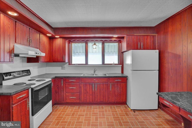 2500 Penn Ave, West Lawn, PA 19609 - kitchen with electric range oven, freestanding refrigerator, under cabinet range hood, a sink, and dark countertops