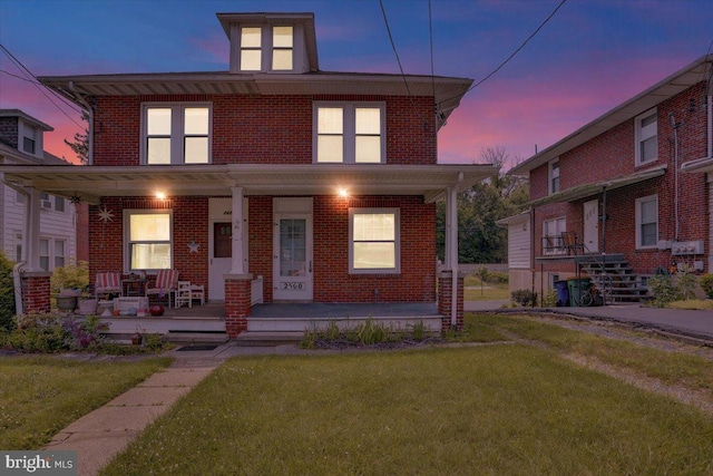 2500 Penn Ave, West Lawn, PA 19609 - american foursquare style home featuring covered porch, brick siding, and a front lawn