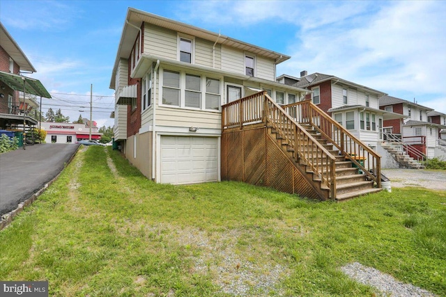 2500 Penn Ave, West Lawn, PA 19609 - rear view of property with stairway, a garage, a wooden deck, and a lawn