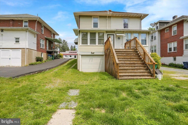 2500 Penn Ave, West Lawn, PA 19609 - rear view of property with an attached garage, a lawn, and stairway