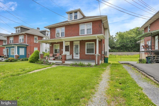 2500 Penn Ave, West Lawn, PA 19609 - american foursquare style home with brick siding, a porch, and a front lawn