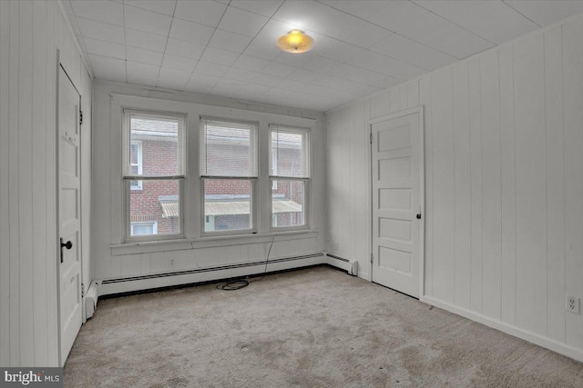 2500 Penn Ave, West Lawn, PA 19609 - carpeted empty room with a baseboard heating unit and wood walls