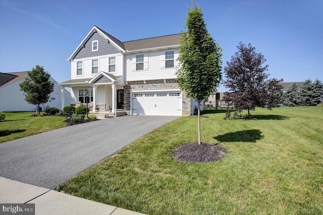 21 Bayberry Rd, Carlisle, PA 17013 - view of front of home featuring stone siding, asphalt driveway, an attached garage, and a front lawn