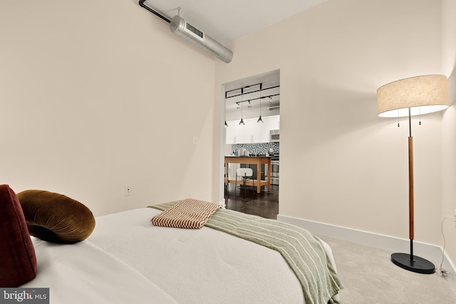 2125 14th St NW Unit 427, Washington, DC 20009 - bedroom featuring rail lighting and carpet flooring