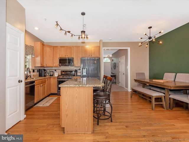 6529 Carston Ct, Frederick, MD 21703 - kitchen featuring stainless steel appliances, a chandelier, light wood finished floors, light brown cabinets, and recessed lighting