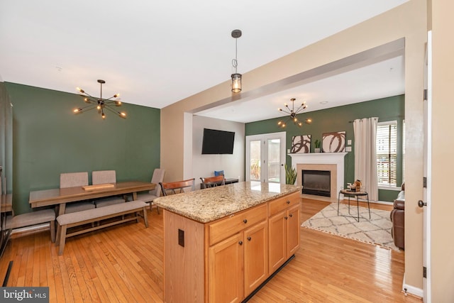 6529 Carston Ct, Frederick, MD 21703 - kitchen with a chandelier, open floor plan, light wood-type flooring, decorative light fixtures, and a center island