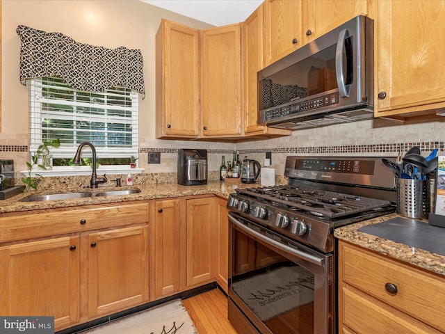 6529 Carston Ct, Frederick, MD 21703 - kitchen featuring stainless steel appliances, a sink, light stone counters, and decorative backsplash