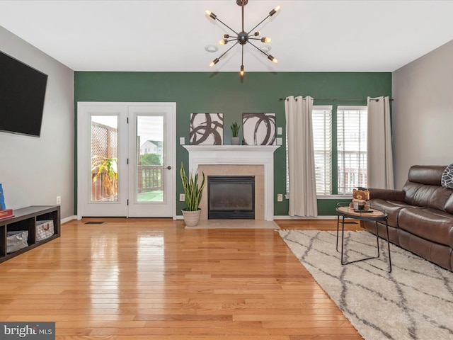 6529 Carston Ct, Frederick, MD 21703 - living area with hardwood / wood-style floors, a chandelier, and a fireplace with flush hearth