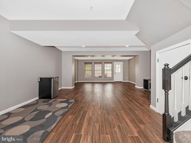 6529 Carston Ct, Frederick, MD 21703 - unfurnished living room featuring dark wood-style flooring, stairs, and baseboards
