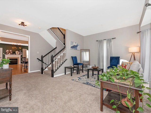 6529 Carston Ct, Frederick, MD 21703 - carpeted living area featuring stairway, baseboards, and a fireplace