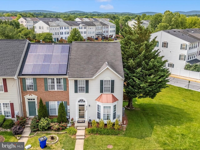 6529 Carston Ct, Frederick, MD 21703 - townhome / multi-family property featuring a residential view, a front yard, roof mounted solar panels, and a mountain view