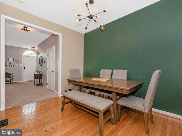 6529 Carston Ct, Frederick, MD 21703 - dining room with a chandelier, light wood-style floors, and baseboards