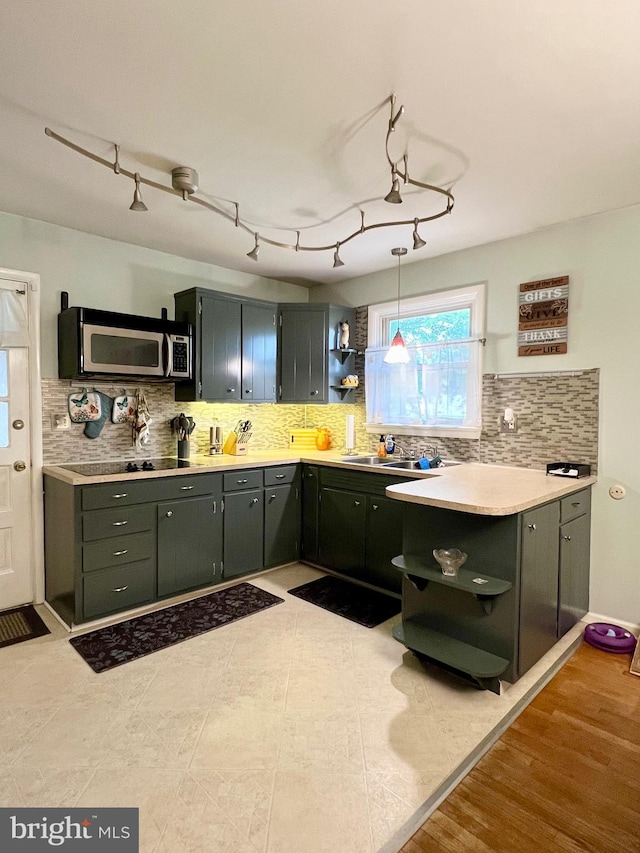 838 N Hanover St, Pottstown, PA 19464 - kitchen with open shelves, stainless steel microwave, tasteful backsplash, light countertops, and decorative light fixtures