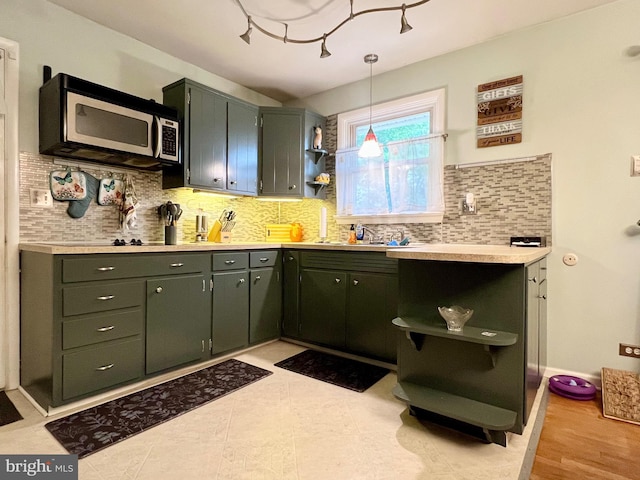838 N Hanover St, Pottstown, PA 19464 - kitchen with open shelves, stainless steel microwave, light countertops, decorative backsplash, and hanging light fixtures