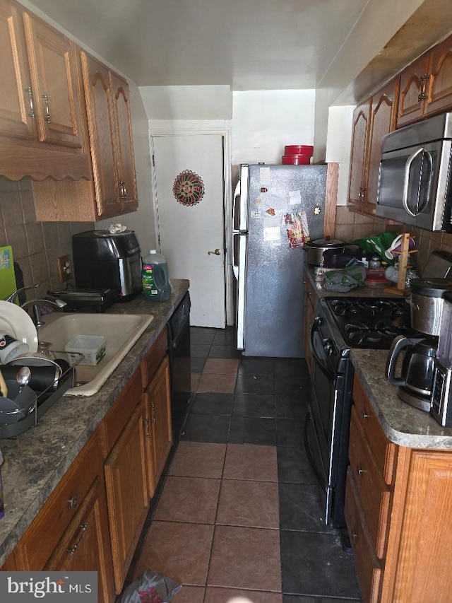 6340 Calvert St, Philadelphia, PA 19149 - kitchen with black appliances, decorative backsplash, a sink, and brown cabinets