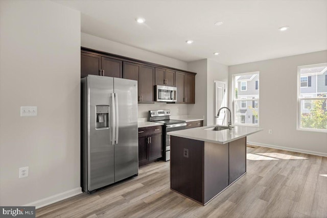 64 Anthem St, Ranson, WV 25438 - kitchen with stainless steel appliances, a sink, dark brown cabinets, light wood-style floors, and recessed lighting
