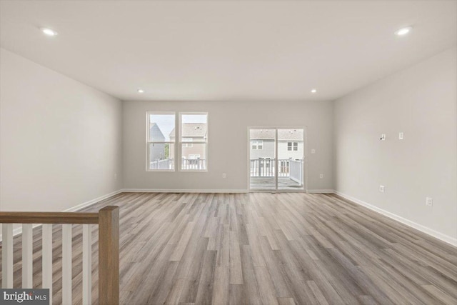 64 Anthem St, Ranson, WV 25438 - unfurnished living room with light wood finished floors, baseboards, and recessed lighting