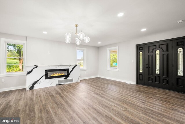 8255 Mertztown Rd, Alburtis, PA 18011 - unfurnished living room featuring baseboards, wood finished floors, plenty of natural light, recessed lighting, and a premium fireplace