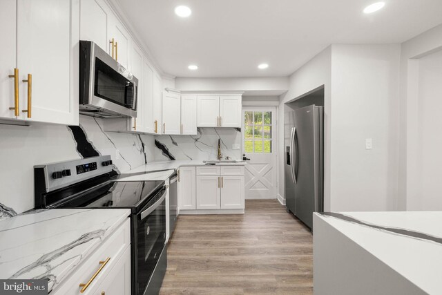 8255 Mertztown Rd, Alburtis, PA 18011 - kitchen with appliances with stainless steel finishes, light wood-style flooring, white cabinetry, recessed lighting, and light stone countertops