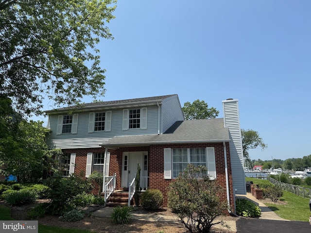 6082 Drum Point Rd, Deale, MD 20751 - view of front of house featuring a chimney and brick siding
