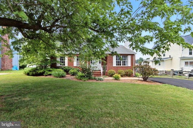 6082 Drum Point Rd, Deale, MD 20751 - view of front of house with a front yard, brick siding, and a chimney
