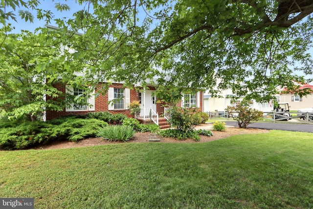 6082 Drum Point Rd, Deale, MD 20751 - obstructed view of property with brick siding and a front yard