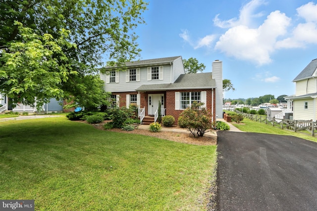 6082 Drum Point Rd, Deale, MD 20751 - view of front of house featuring a chimney, brick siding, and driveway