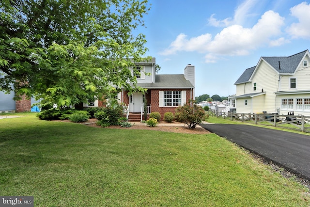 6082 Drum Point Rd, Deale, MD 20751 - view of front of home featuring brick siding, a chimney, and asphalt driveway