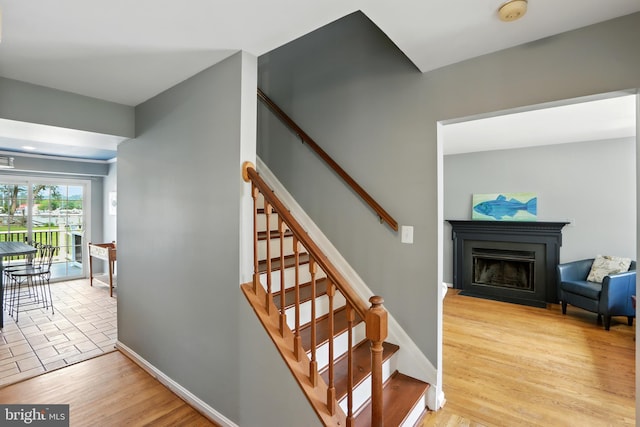 6082 Drum Point Rd, Deale, MD 20751 - stairway with wood finished floors and a fireplace with flush hearth