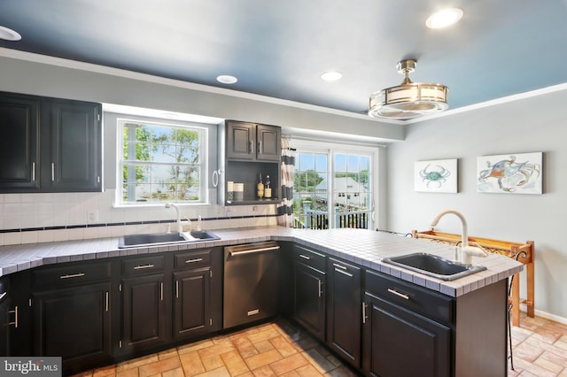 6082 Drum Point Rd, Deale, MD 20751 - kitchen with dishwasher, a peninsula, tile countertops, tasteful backsplash, and light stone finish floors