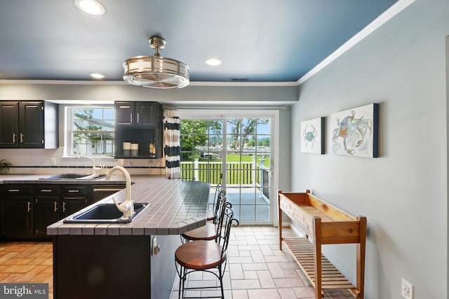 6082 Drum Point Rd, Deale, MD 20751 - kitchen featuring a breakfast bar, backsplash, plenty of natural light, tile countertops, and recessed lighting