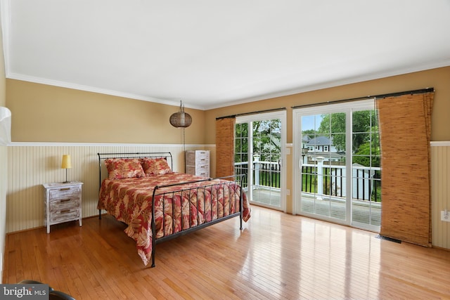 6082 Drum Point Rd, Deale, MD 20751 - bedroom featuring access to outside, hardwood / wood-style floors, ornamental molding, a wainscoted wall, and wood walls