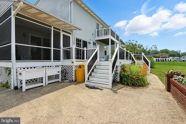 6082 Drum Point Rd, Deale, MD 20751 - rear view of house with a sunroom and stairs