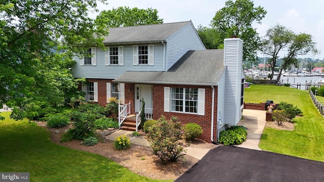 6082 Drum Point Rd, Deale, MD 20751 - view of front of property with a chimney, brick siding, a shingled roof, and a water view