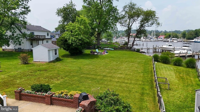 6082 Drum Point Rd, Deale, MD 20751 - view of yard featuring a water view, a storage shed, and a boat dock