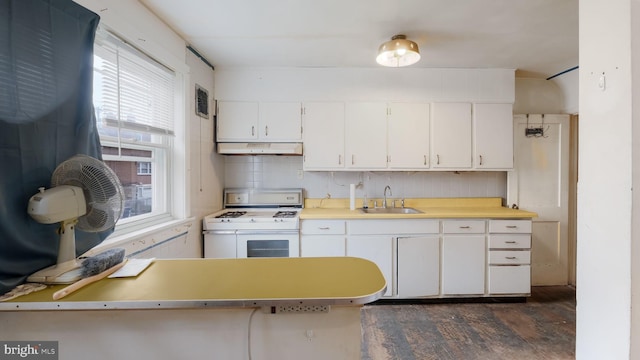 6254 Marsden St, Philadelphia, PA 19135 - kitchen featuring white gas range oven, a sink, ventilation hood, dark wood-style floors, and light countertops