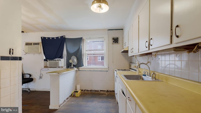 6254 Marsden St, Philadelphia, PA 19135 - kitchen featuring a sink, stove, under cabinet range hood, white cabinets, and cooling unit