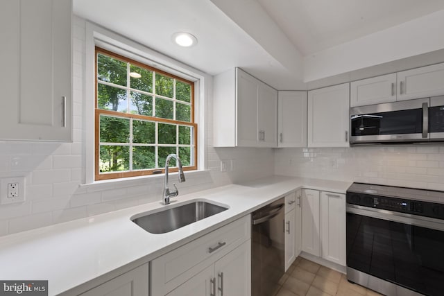 6 Constantine Dr, Phoenix, MD 21131 - kitchen featuring stainless steel appliances, a sink, white cabinets, light countertops, and vaulted ceiling