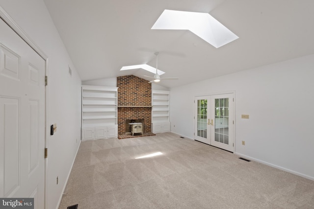 6 Constantine Dr, Phoenix, MD 21131 - unfurnished living room with a skylight, built in features, a wood stove, lofted ceiling, and carpet