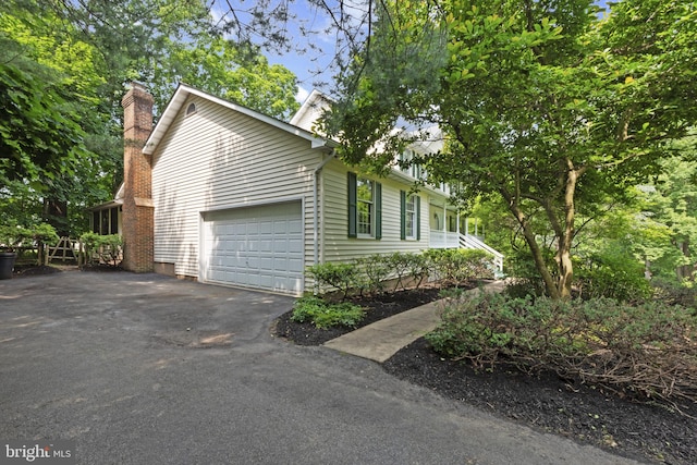 6 Constantine Dr, Phoenix, MD 21131 - view of property exterior featuring driveway, a chimney, and a garage