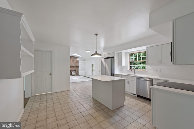 6 Constantine Dr, Phoenix, MD 21131 - kitchen featuring appliances with stainless steel finishes, tasteful backsplash, a center island, a brick fireplace, and decorative light fixtures