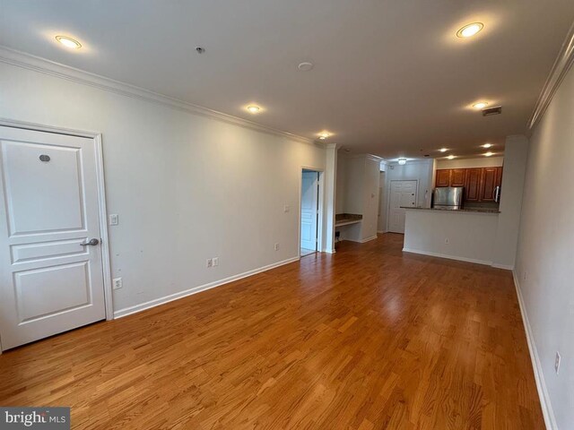 12000 Market St Unit 324, Reston, VA 20190 - unfurnished living room featuring ornamental molding, baseboards, light wood-style floors, and recessed lighting