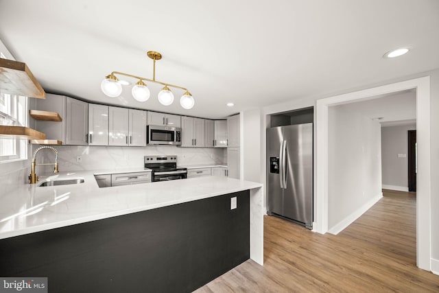 8255 Mertztown Rd, Alburtis, PA 18011 - kitchen with appliances with stainless steel finishes, a sink, open shelves, a peninsula, and tasteful backsplash
