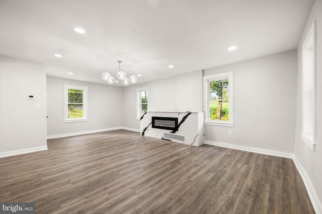 8255 Mertztown Rd, Alburtis, PA 18011 - unfurnished living room with a fireplace, recessed lighting, dark wood-style floors, baseboards, and a chandelier